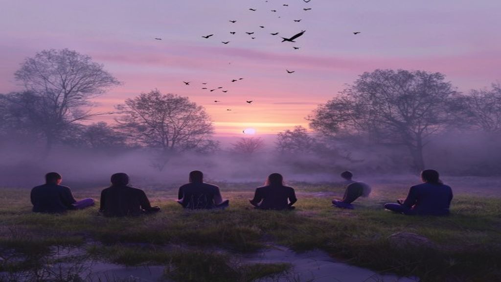 Group sitting at dawn outdoors